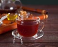 Cup of herbal tea with flowers, honey in jar, teapot and and various dried herbs on the tray. Royalty Free Stock Photo