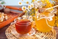 Cup of herbal tea with flowers, honey in jar, teapot and and various dried herbs on the tray. Royalty Free Stock Photo