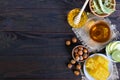 A cup of herbal tea, honey, honeycomb, hazelnuts on a dark wooden background. Royalty Free Stock Photo