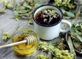 Cup of herbal tea and honey. medicinal herbs. remedy for flu and cold Royalty Free Stock Photo