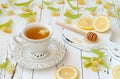 Cup of herbal tea with linden flowers, lemon and honey on a old wooden background. Royalty Free Stock Photo