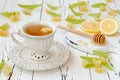 Cup of herbal tea with linden flowers, lemon and honey on a old wooden background. Royalty Free Stock Photo