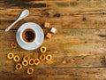 A Cup of herbal tea, a spoon and and bagels on an old worn Board. Copy space Royalty Free Stock Photo