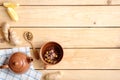 Cup of herbal tea, spoon with dried tea, teapot, napkin, ginger root and lemon on wooden background, view from above with copy Royalty Free Stock Photo