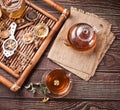 Cup of herbal tea with teapot and wooden tray with various dry herbs. Top view Royalty Free Stock Photo