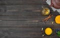 Cup of herbal tea - turmeric and spices on wooden background. Ceramic teapot with tea and bowl with ground turmeric and