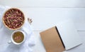 A cup of hot aroma rose tea with dry rose buds in a basket on a white wooden background. Royalty Free Stock Photo