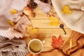 Cup of hot aromatic coffee, autumn leaves, apple, cozy scarves and knitted sweaters, flat, concept of hugg, winter or autumn mood Royalty Free Stock Photo