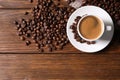 Cup of hot aromatic coffee and roasted beans on wooden table, flat lay Royalty Free Stock Photo