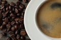 Cup of hot aromatic coffee and roasted beans on wooden table, top view. Space for text Royalty Free Stock Photo