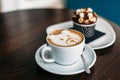 Cup of hot bear latte art coffee with delicious cupcake Royalty Free Stock Photo