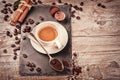 Cup of hot black coffee in setting with roasted coffee beans Royalty Free Stock Photo