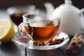 Cup of hot black tea with lemon and spices in glass cup on black Royalty Free Stock Photo