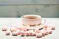 Cup with hot black tea and marshmallows. Cup and sweets prepared as dessert. Tea break concept. Mug filled with black Royalty Free Stock Photo