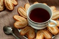 A cup of hot black tea with puff pastry. Royalty Free Stock Photo