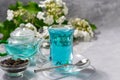 A cup of hot, blue tea with pea flowers. Blue peas. For healthy drinking, detoxifying the body. Gray background Royalty Free Stock Photo
