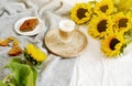 Cup with hot cappuccino, gray pastel woolen blanket, sunflowers, bedroom