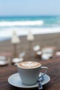 Cup of hot cappucino on wooden table background. Royalty Free Stock Photo