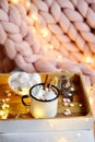 Cup with hot chocolate, bowl with marshmallows, jar with chocolate, pink pastel giant plaid Royalty Free Stock Photo