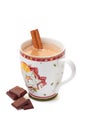 Cup of hot chocolate with cinnamon stick and pieces on white Royalty Free Stock Photo