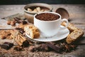 Cup of hot chocolate, cinnamon sticks, nuts and chocolate