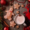 Cup of hot chocolate or cocoa with gingerbread man, warm scarf composition in fir tree decoration. Square view