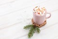 A cup of hot chocolate coffee, cocoa with marshmallows inside of it on a white wooden background planks