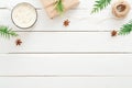 Cup of hot chocolate with marshmallow, fir tree branches, gift, Christmas decorations on wooden white background. Flat lay, top Royalty Free Stock Photo