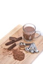 Cup of hot chocolate, measuring spoon, chocolate powder and choc Royalty Free Stock Photo