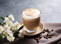 Cup of hot chocolate with whipped cream light grey marble table with white flowers. Cozy winter or autumn hot drink made of grated