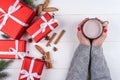 Cup of hot cocoa or chocolate in girl hands with red manicure. Flat lay, top view. Young woman in sweater with cacao mug. Royalty Free Stock Photo