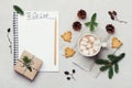 Cup of hot cocoa or chocolate with marshmallow, cookies and notebook with christmas to do list on white table from above. Royalty Free Stock Photo