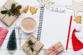Cup of hot cocoa, holiday decorations, gift, present, miniature fir tree and notebook with Christmas to do list on white table.