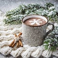 Cup of hot cocoa or hot chocolate on knitted background with fir tree and snow effect, traditional beverage for winter time Royalty Free Stock Photo