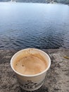 a cup of hot coffe by the lake in the morning Royalty Free Stock Photo