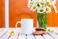 Cup of hot coffee, biscuits and a bouquet of chamomiles Royalty Free Stock Photo