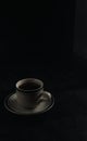 a cup of hot coffee on a black background. dark scene. banner space mock-up for adding text Royalty Free Stock Photo