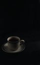a cup of hot coffee on a black background. dark scene. banner space mock-up for adding text Royalty Free Stock Photo