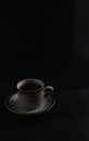a cup of hot coffee on a black background. dark scene. banner space mock-up for adding text Royalty Free Stock Photo