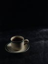 a cup of hot coffee on a black background. dark scene. banner space mock-up for adding text Royalty Free Stock Photo