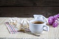 Cup of hot coffee with books, milk and flowers on wooden table Royalty Free Stock Photo