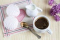 Cup of hot coffee with books, milk and flowers on wooden table Royalty Free Stock Photo