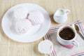 Cup of hot coffee with books, milk and flowers on wooden table Royalty Free Stock Photo