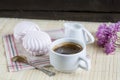 Cup of hot coffee with books, milk and flowers on wooden table Royalty Free Stock Photo