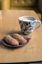 Cup of Hot Coffee with bread cookies served on wooden table Royalty Free Stock Photo