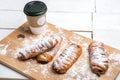 Cup of hot coffee with cakes on the wooden table on white background. Fast breakfast. French cuisine. Good morning Royalty Free Stock Photo