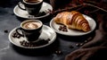 Cup Hot coffee Cappuccino and croissant on a dark old wooden background in morning light. Breakfast concept