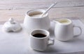 Cup of hot coffee espresso, coffee beans, jug of milk, and bowl with sugar on white background for copy space. Coffee Royalty Free Stock Photo