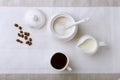 Cup of hot coffee espresso, coffee beans, jug of milk, and bowl with sugar on white background for copy space. Coffee Royalty Free Stock Photo