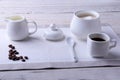 Cup of hot coffee espresso, coffee beans, jug of milk, and bowl with sugar on white background for copy space. Coffee Royalty Free Stock Photo